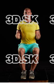 Sitting reference of whole yellow shirt turquoise shorts brown shoes…